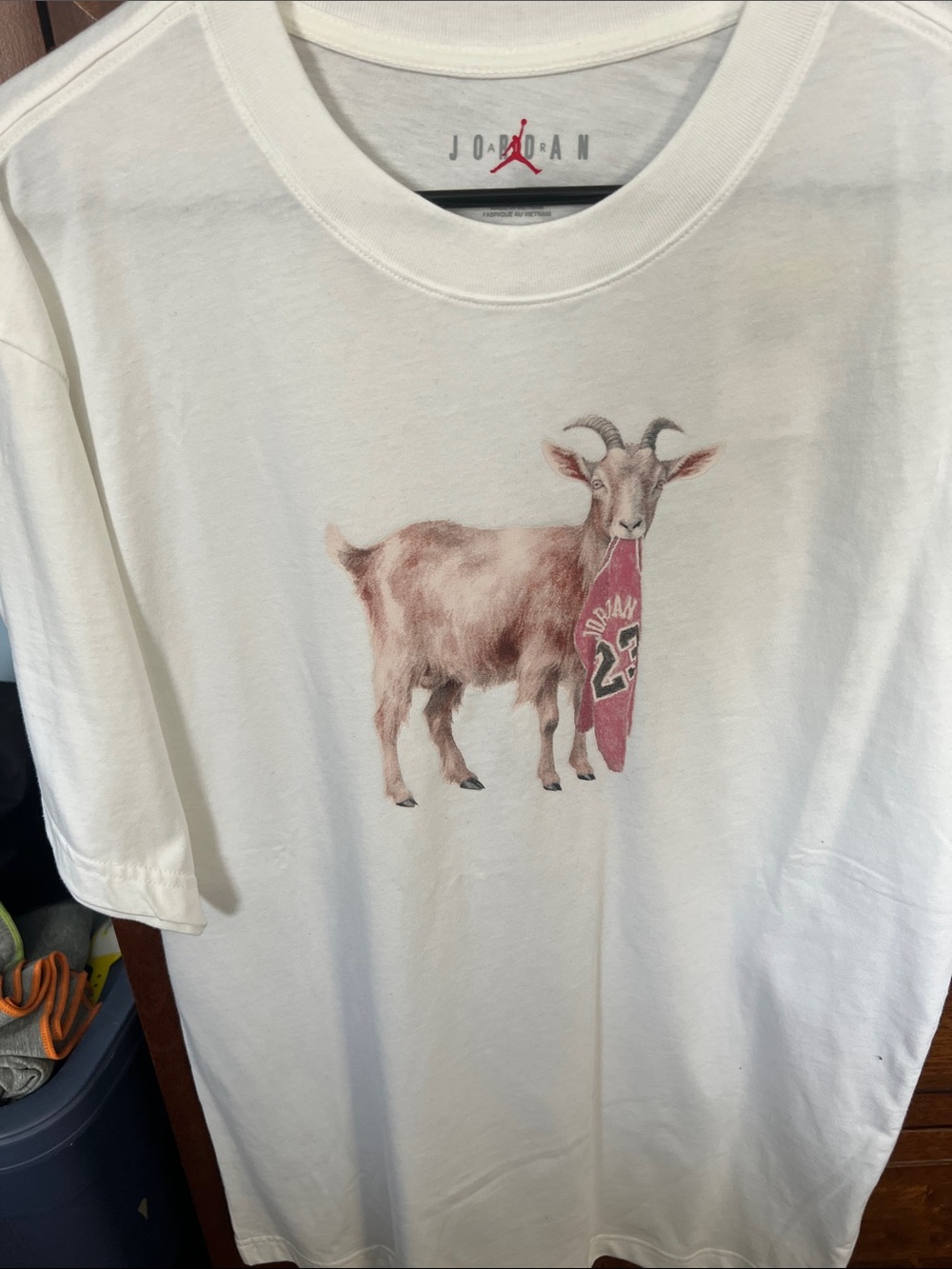 Jordan White Kids Tee with Goat Holding Red Jersey Graphic